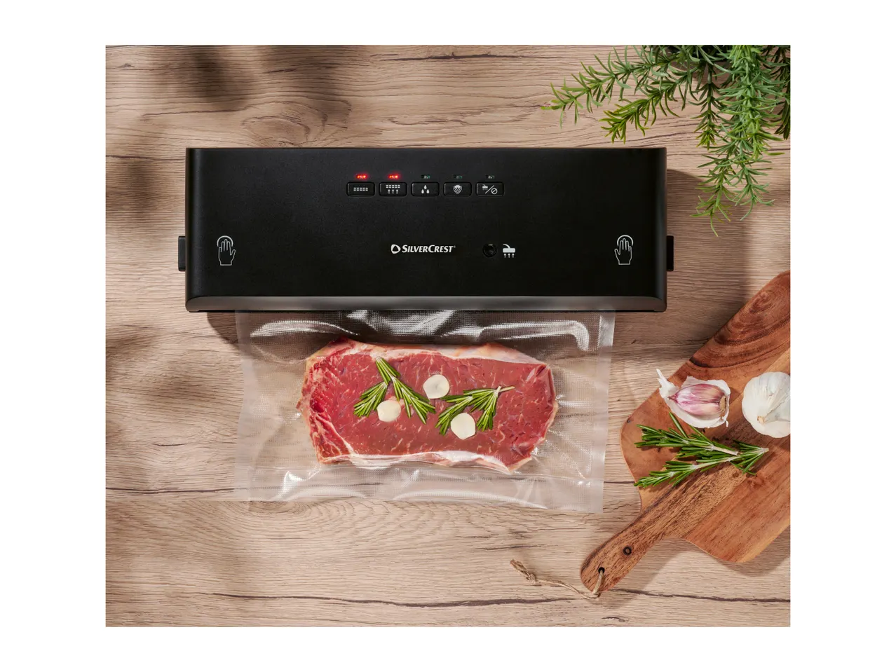 Vacuum sealer machine on a kitchen counter with sealed food bags